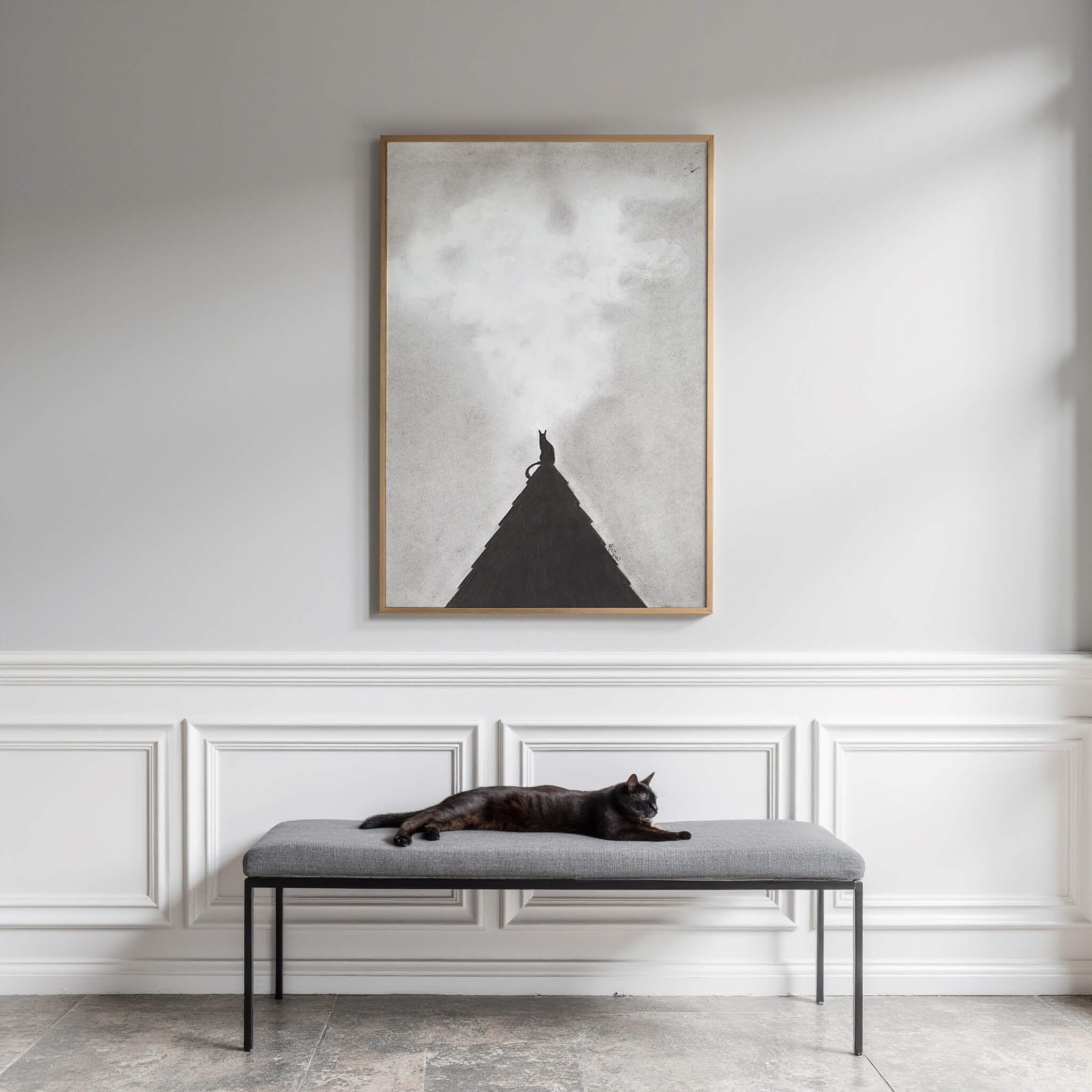 Midnight Perch black cat art print framed above an entryway bench with wainscoting