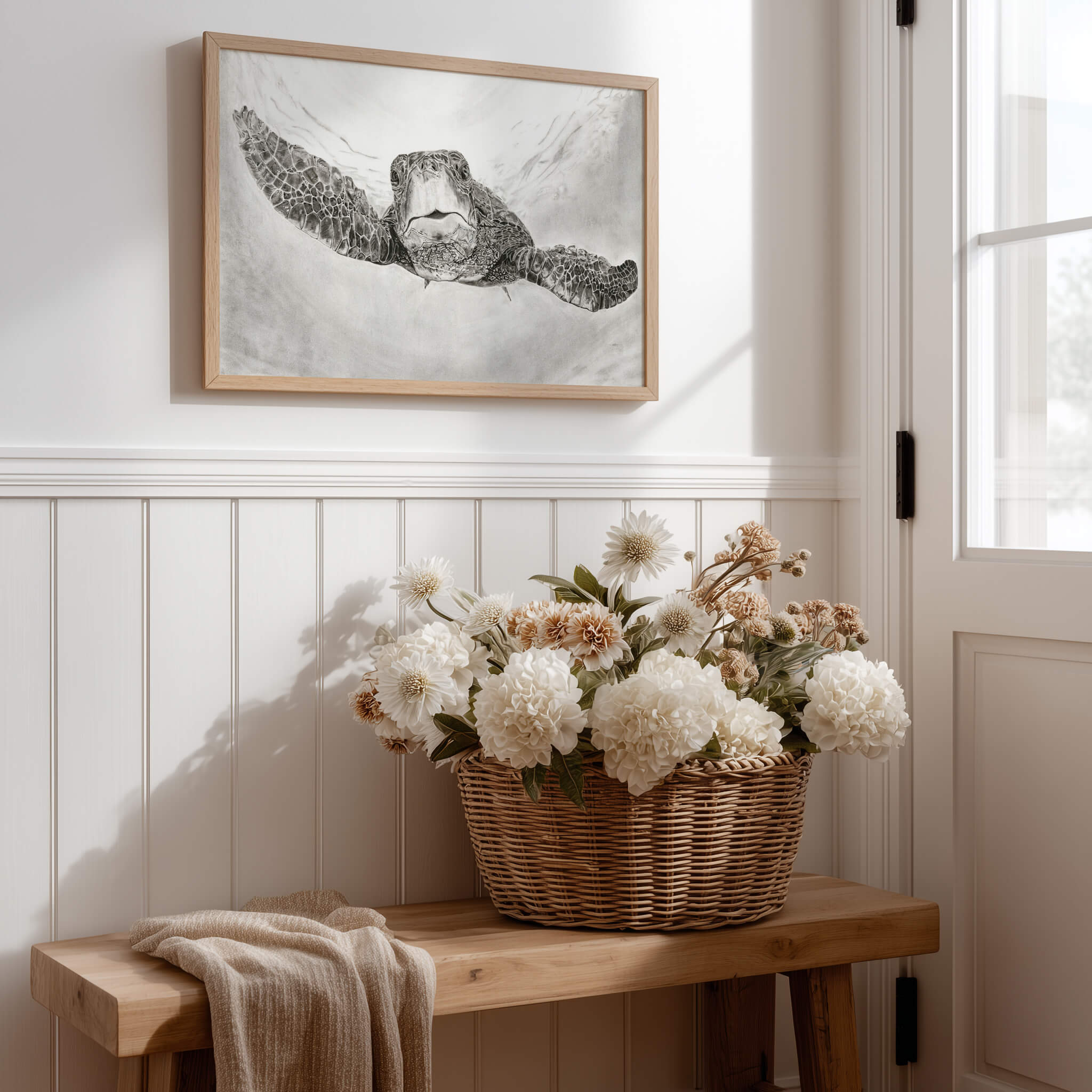 The Great Navigator sea turtle drawing art print in an oak frame above a farmhouse entryway bench