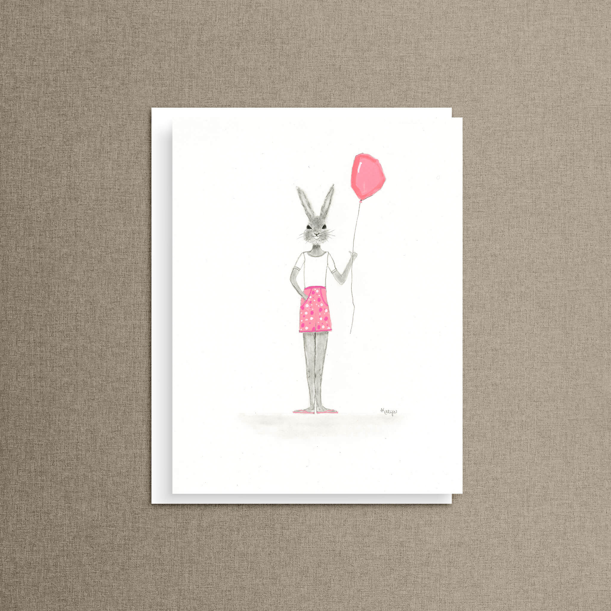 Balloon bunny note card featuring a bunny in pink polka dot shorts holding a pink balloon