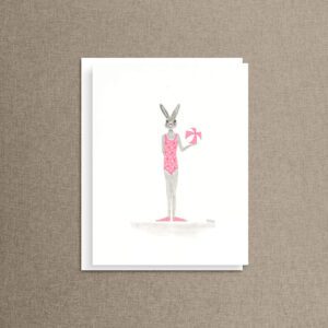 Whimsical bunny rabbit note card featuring a bunny in a pink polka-dot swimsuit holding a beach ball, styled on a soft linen background — a cute animal card ready to brighten someone's day.
