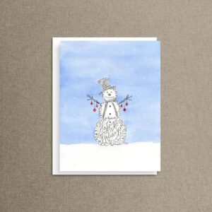 Frosty Flourishes snowman christmas card featuring a calligraphy-style snowman with "Happy Holidays" hand-lettered across its belly, red berry buttons, and falling snow on a soft blue watercolor background.
