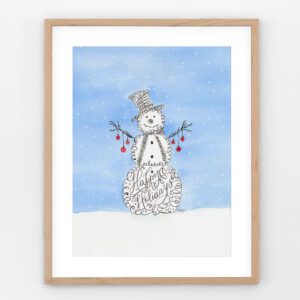 Message in the Snow art print featuring a calligraphy snowman with “Happy Holidays” in the body, branches with baubles, and a bright blue sky — uplifting Christmas décor.