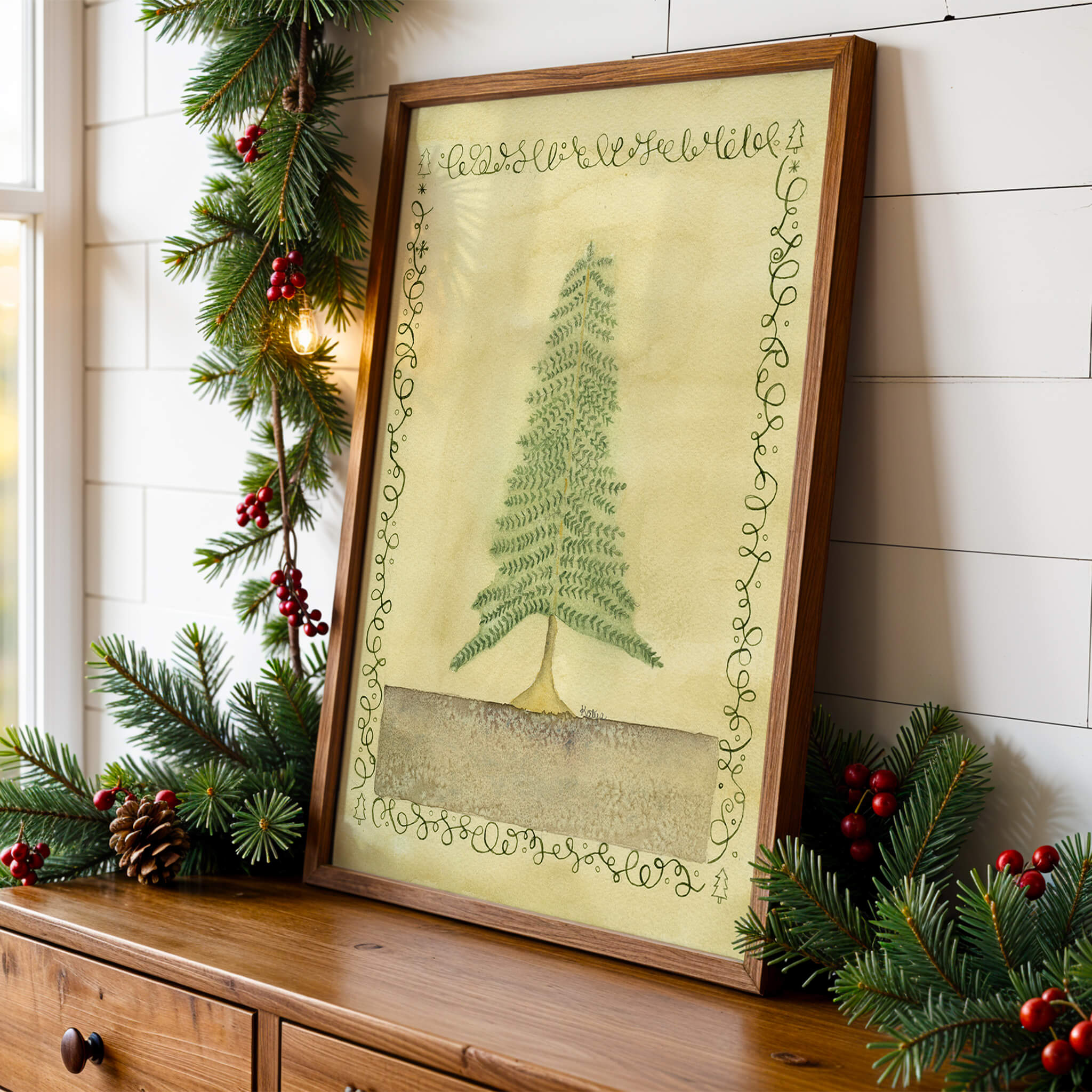Original pine tree watercolor painting displayed on a wood dresser with pine garland and pinecones