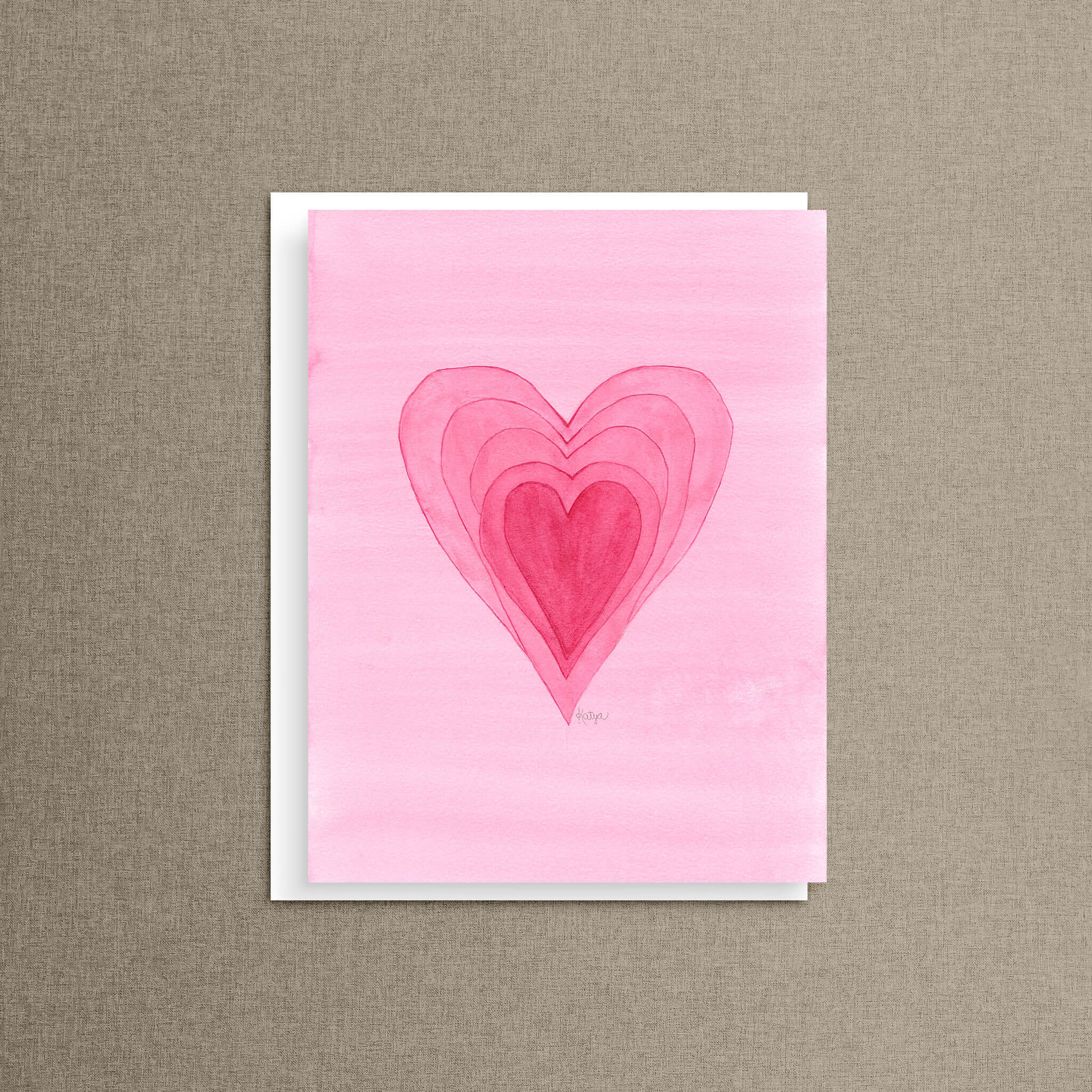 Full of Hearts card featuring five nested pink hearts forming one heart shape, propped on a white envelope against a warm linen background
