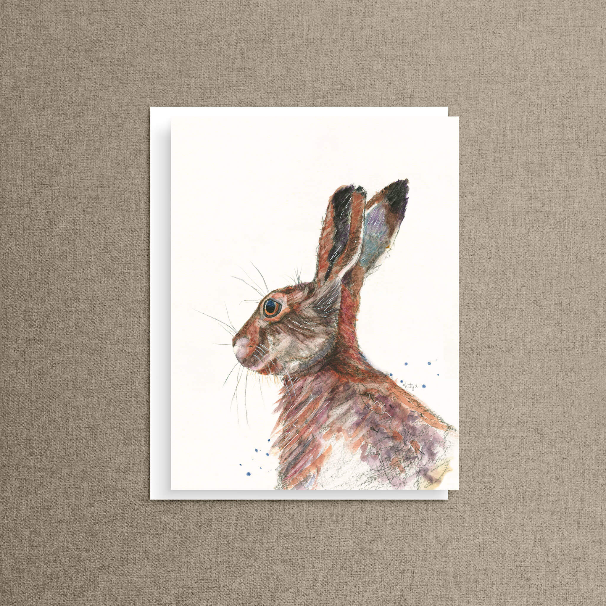 Colorful rabbit note card displayed on a warm taupe linen background — watercolor bunny art by Cathy Turner.