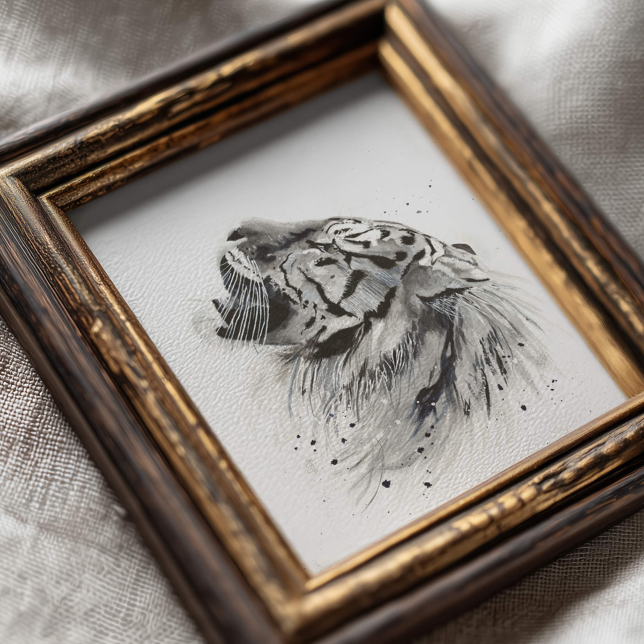 Untamed black and white tiger print in an ornate gold frame, styled detail shot