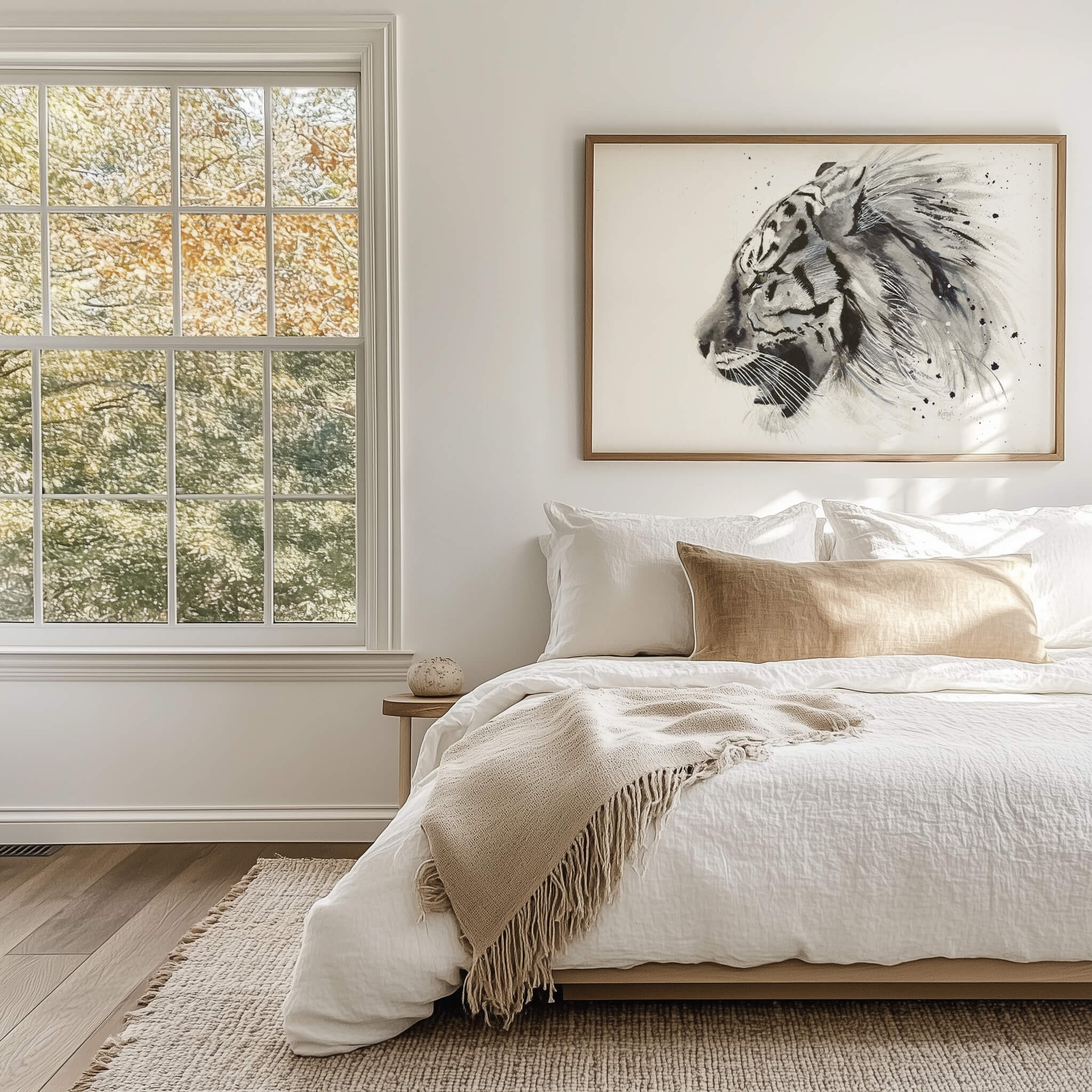 Untamed black and white tiger print framed above a bed in a light, neutral bedroom