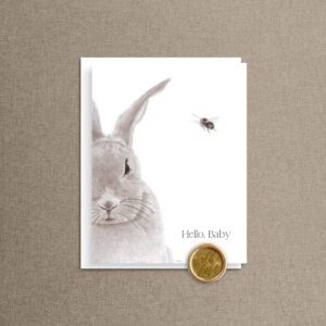 Hello, Baby newborn congrats card featuring a bunny and a tiny bee, with envelope and a gold "with love" wax seal on natural linen
